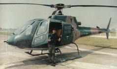 Marcos Dreher standing in front of a helicopter