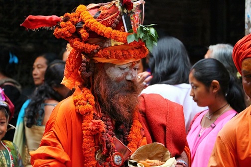 Picture of Nepalese man painted with traditional religious colours. 