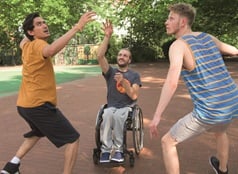 Man in wheelchair playing basketball 