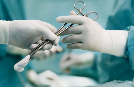 A hand reaching over an operation instrument to another hand.