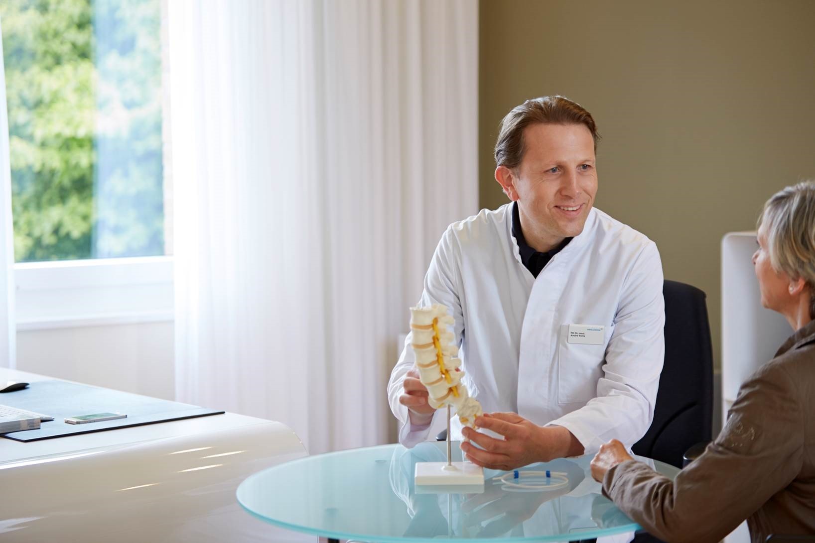 Dr. Reitz talking to a female patient in his medical practice