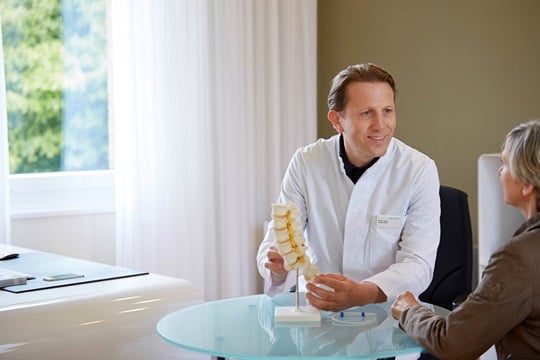 Dr. Reitz talking to a female patient in his medical practice