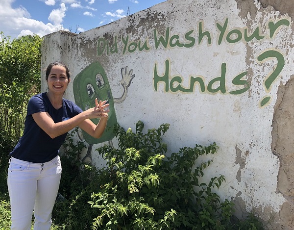 Elisa Pizzi standing in front of a colourful wall in Kenya.