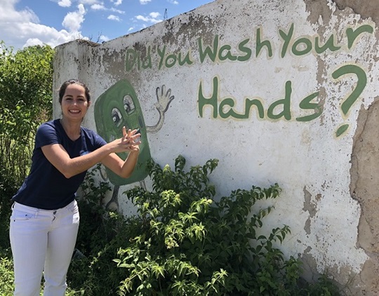 Elisa Pizzi standing in front of a colourful wall in Kenya.