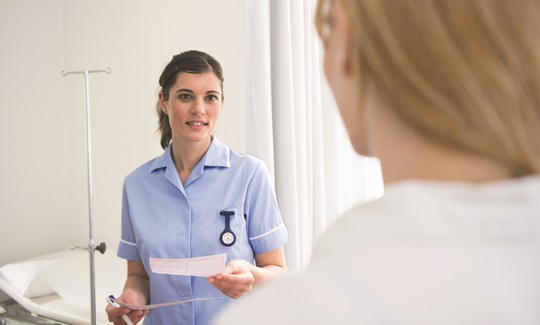 A female nurse talking to a patient