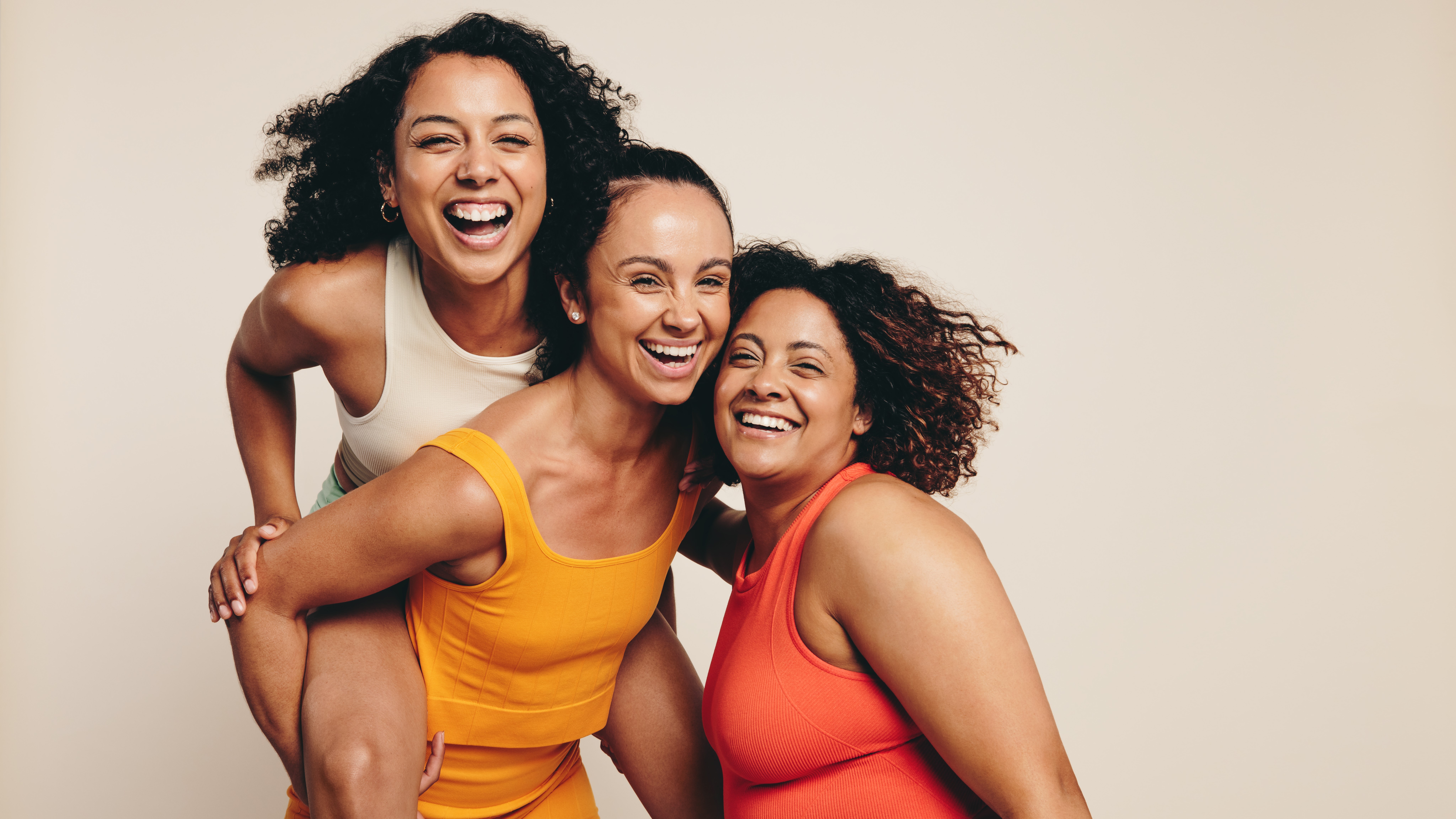 Three younger women in yoga clothing and underwear having fun 