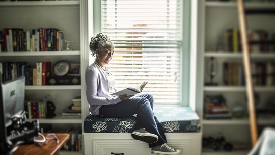 Image of a woman looking through a window