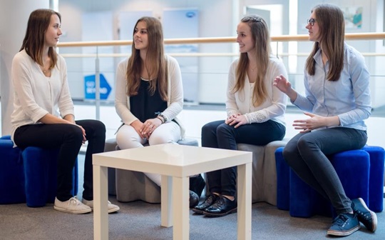 Members of the YoungTalents sitting together talking