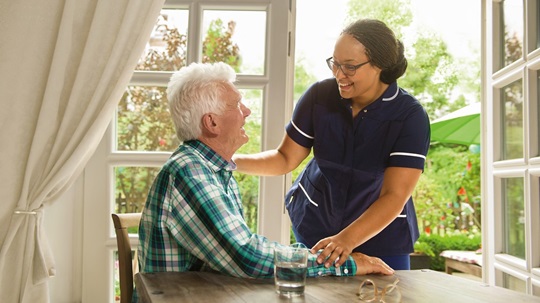 Nurse holding hand of patient