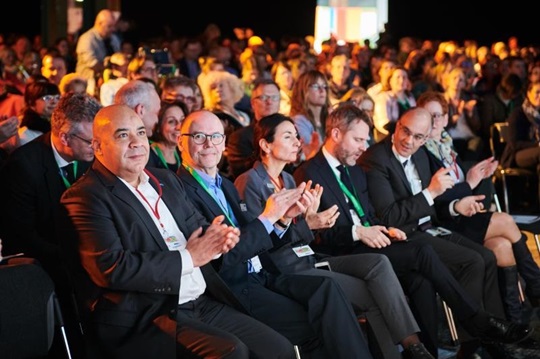 Chima Abuba and Raimund Koch sitting in the audience at the German Nursing Day