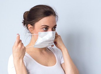 putting on a respirator mask