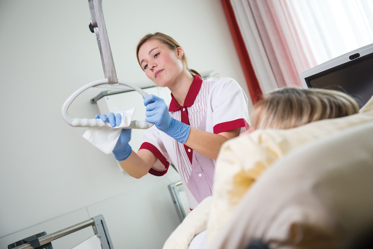 Two hands putting on sterile gloves. 