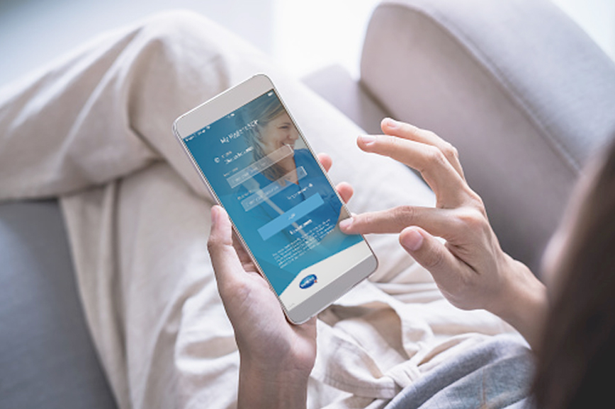 View from top on person holding phone and scrolling through app