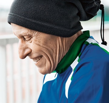An elder man is happily smiling