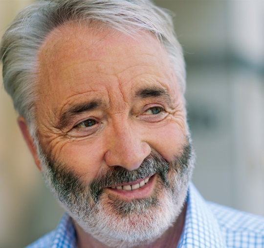 A smiling elderly man