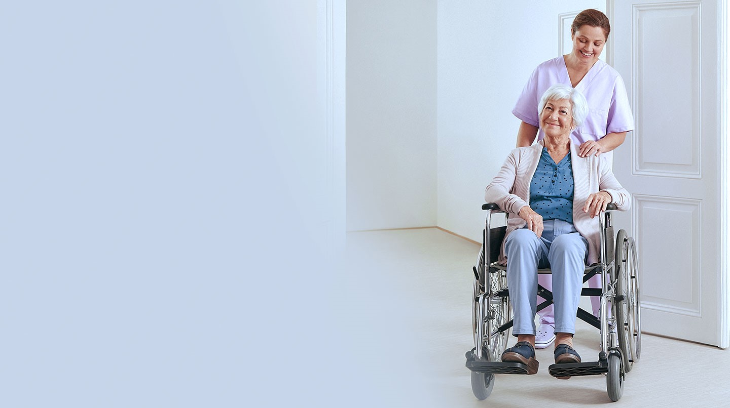 A nurse looks after an elderly woman in a nursing home.