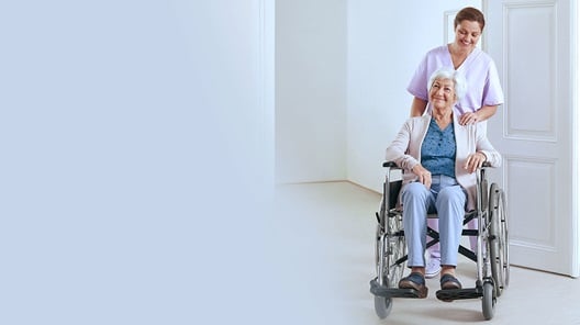 A nurse looks after an elderly woman in a nursing home.