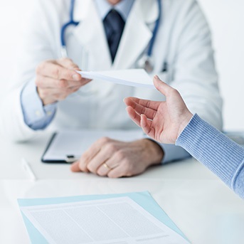 Arzt überreicht Patientin Entlassungsschein