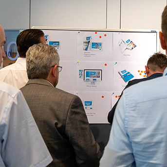 MORE4MORE Event Gruppe von hinten vor Whiteboard