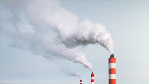 White smoke billowing from the chimneys of a power station.