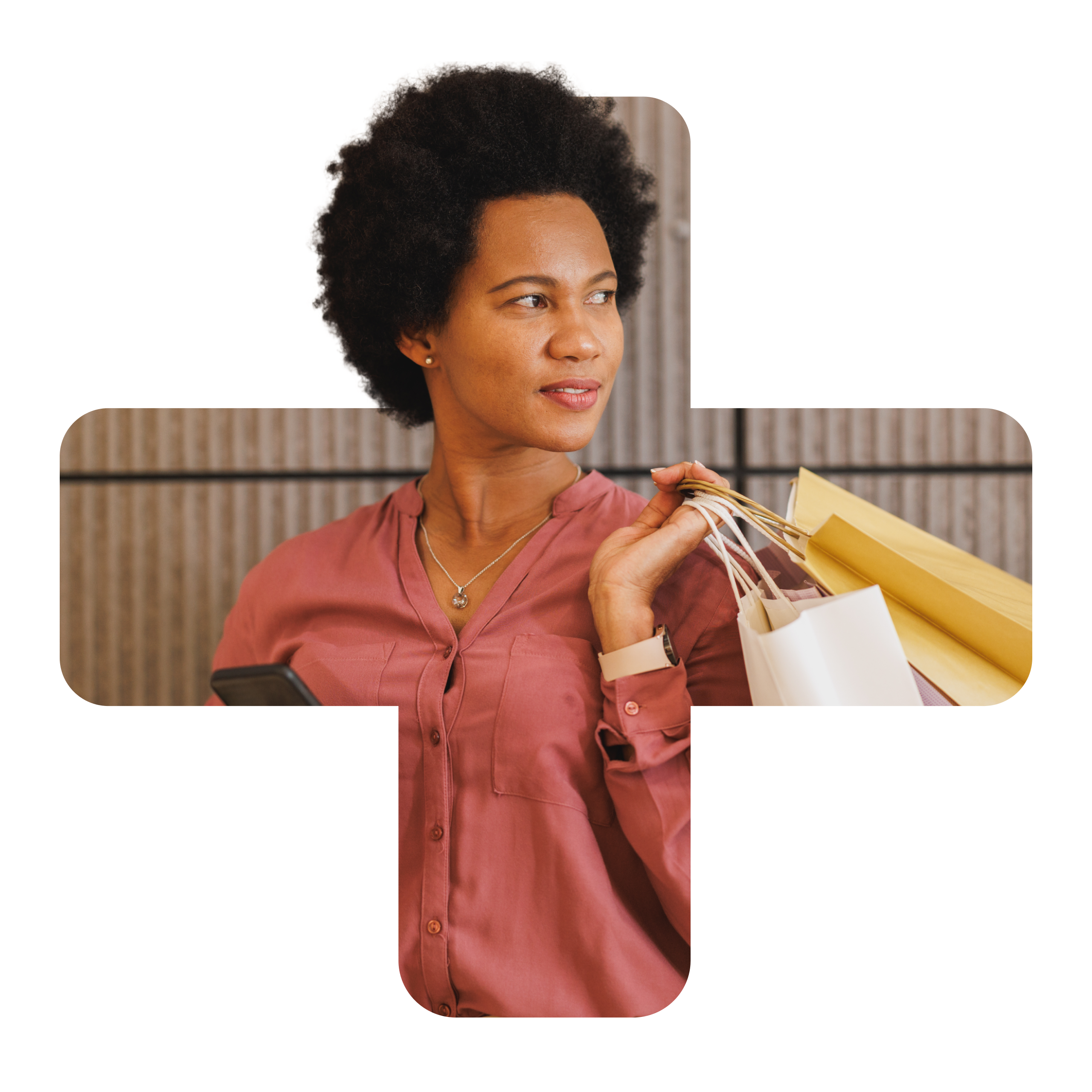 Confident woman holding multiple shopping bags and using smartphone, standing against a modern textured wall.