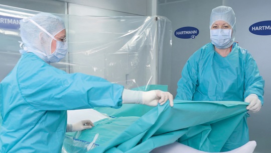 Nurses draping patient.