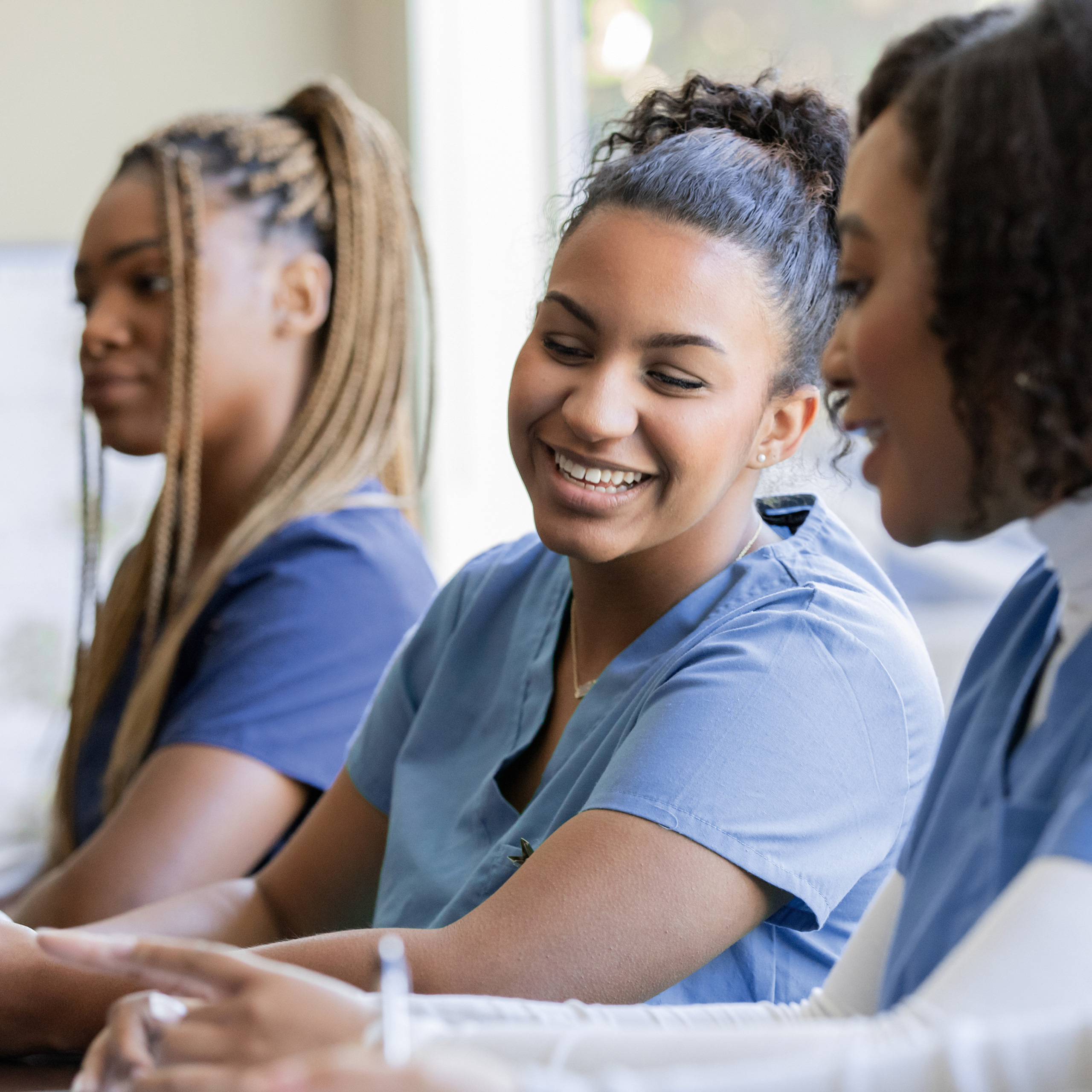 Several nurses chatting and laughing.