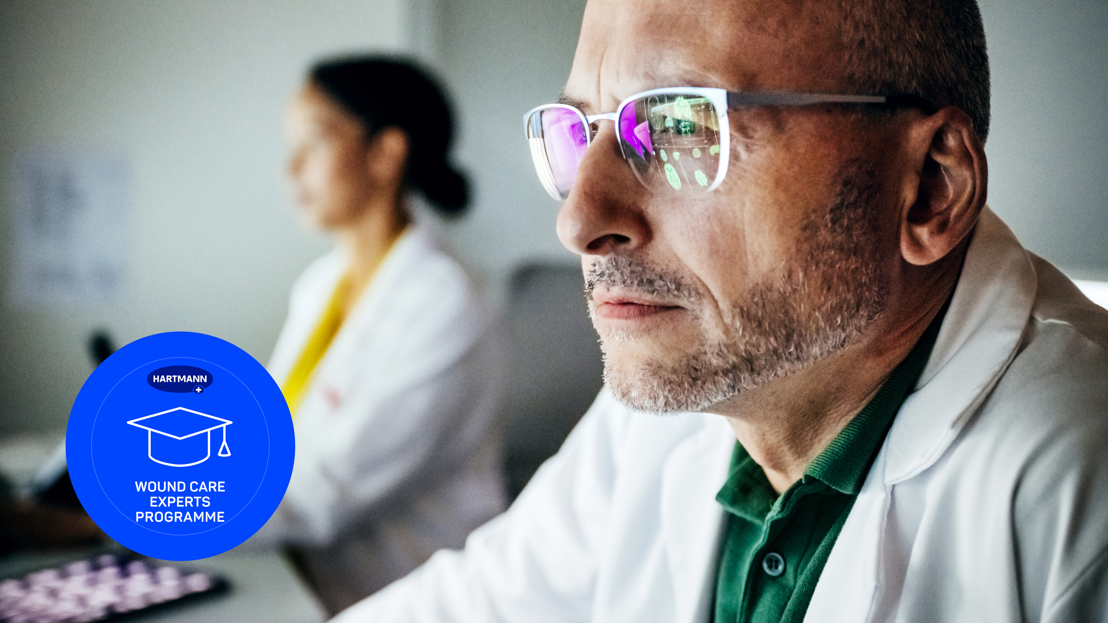 Middle-aged scientist in a laboratory, looking intently at a screen.