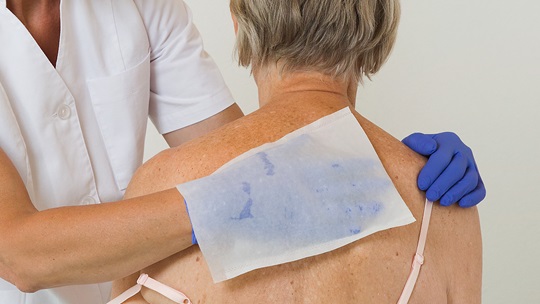 Rücken einer Seniorin wird mit Cala Clean abgerieben