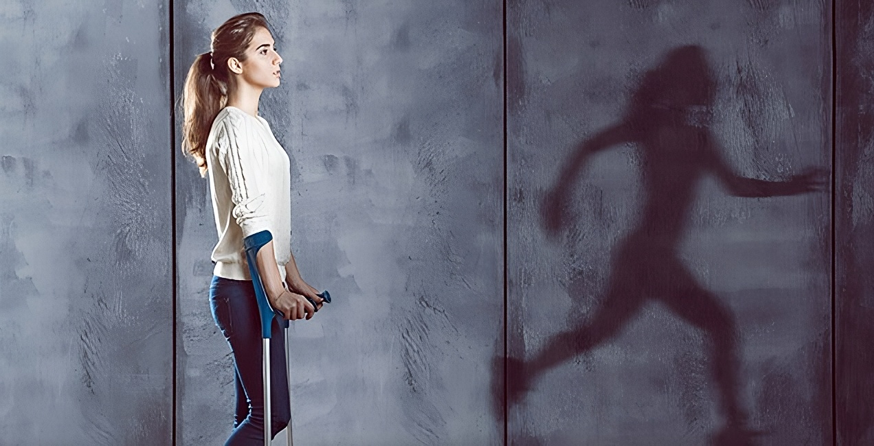 Young woman on crutches standing against a wall, with a shadow showing her running freely—symbolizing hope, recovery, and inner strength.
