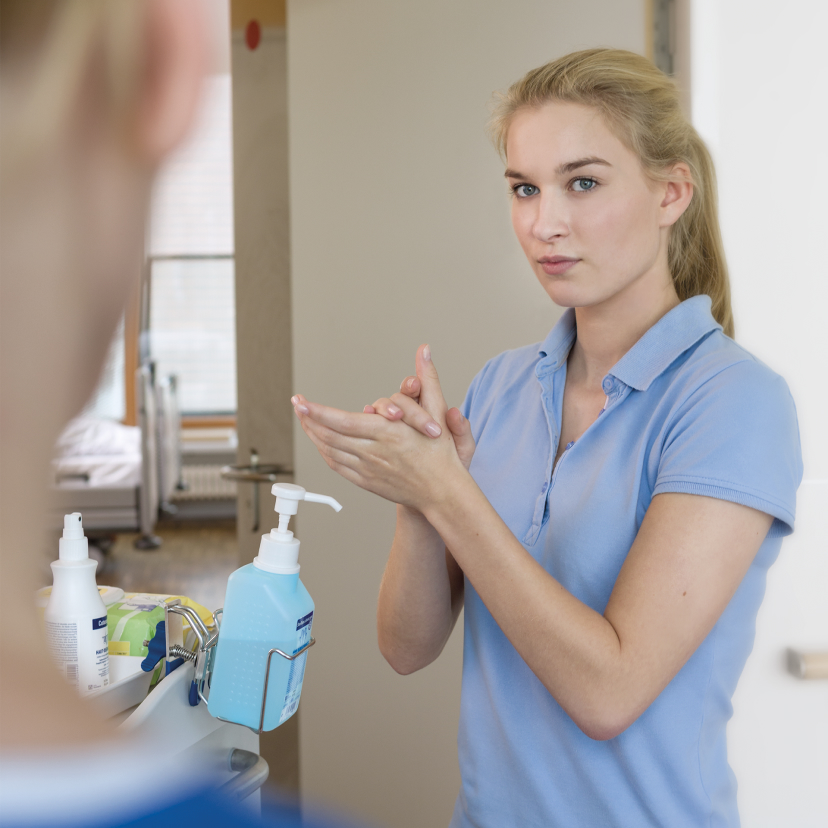  A female nurse disinfects her hands with Sterillium®.