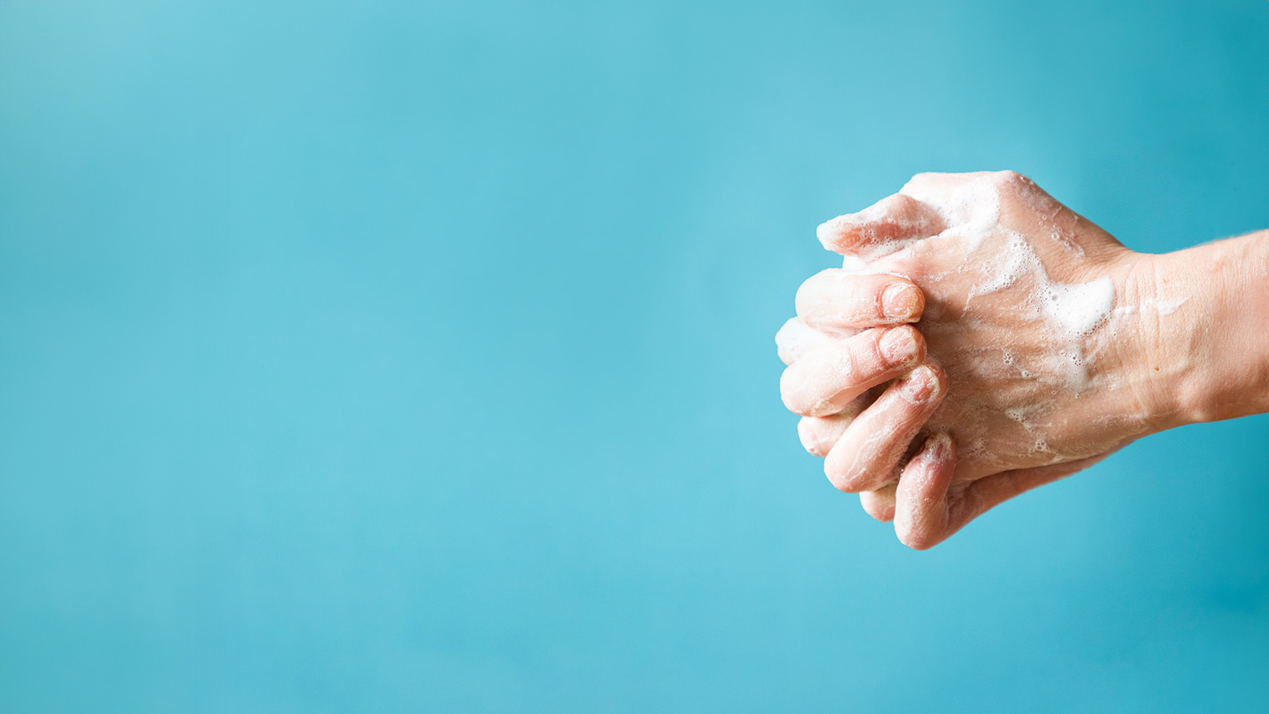 Set of hands washing in front of blue background.