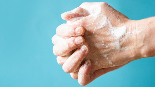 Set of hands washing in front of blue background.