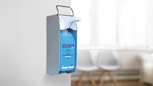 Sterillium® pump mounted on a wall in doctors office.