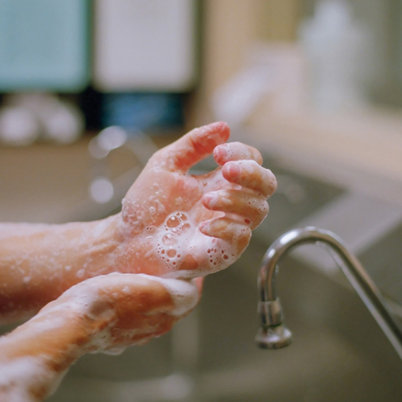 Close-up of hands covered in soap suds.