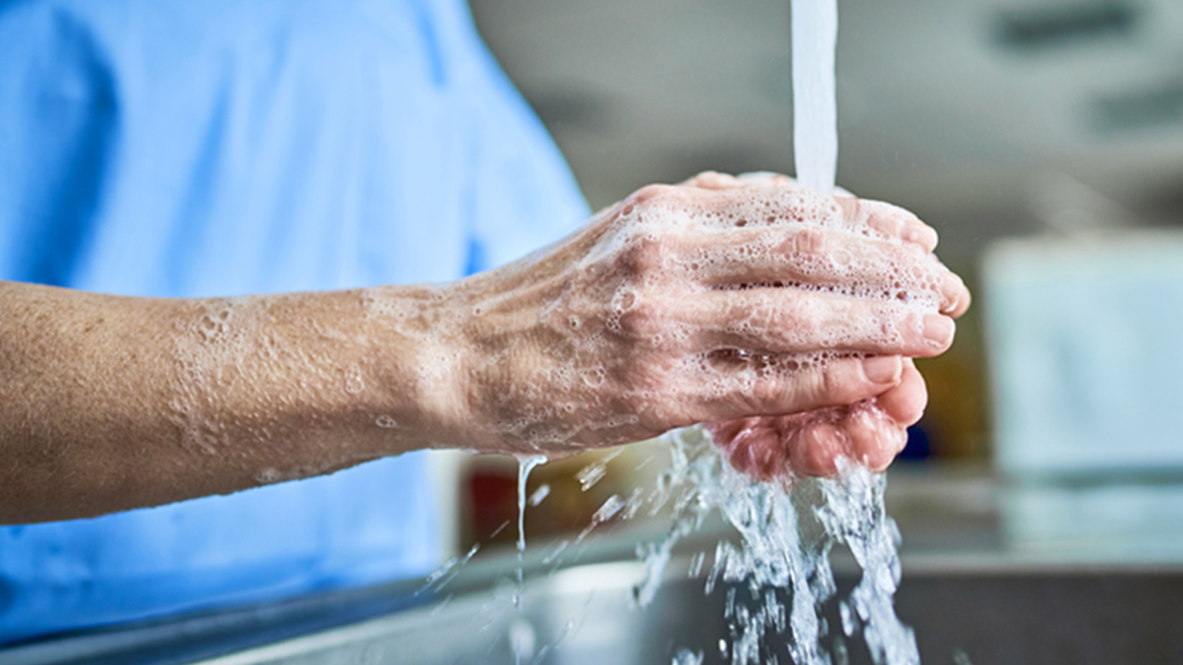Someone washes their hands with soap and running water.