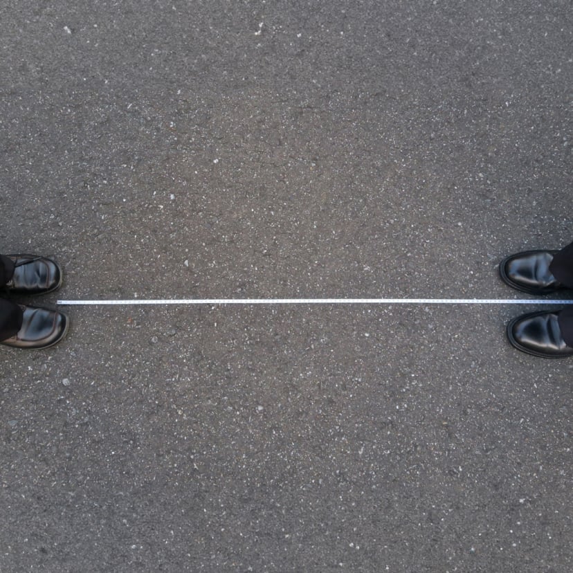 Image from above of shoes facing each other but with a wide distance between them.