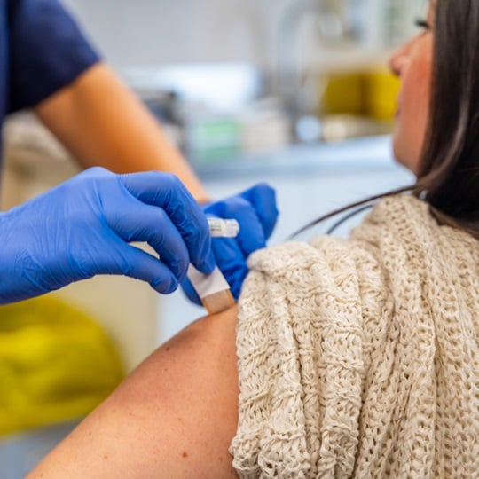 Image of woman being vaccinated.