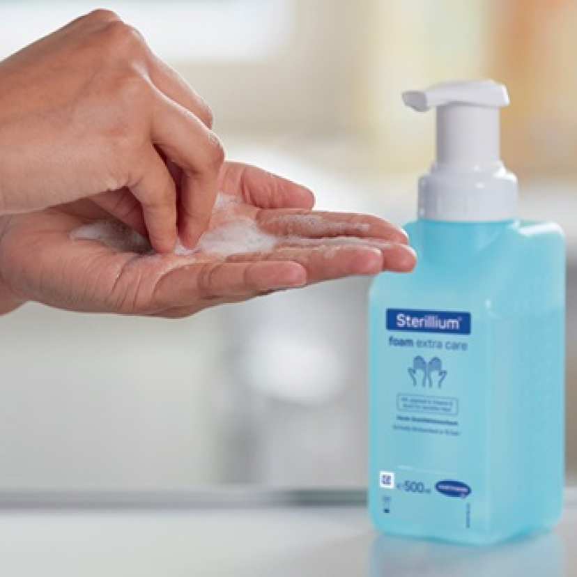 Close-up of hands being disinfected.