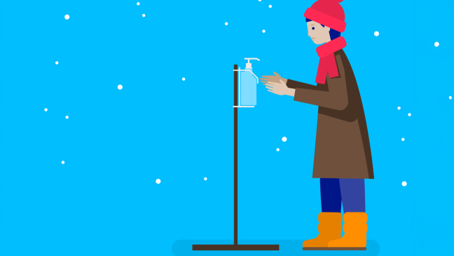 Illustration: A woman in winter clothing disinfects her hands.