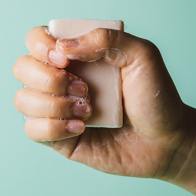 A hand holding a bar of soap.