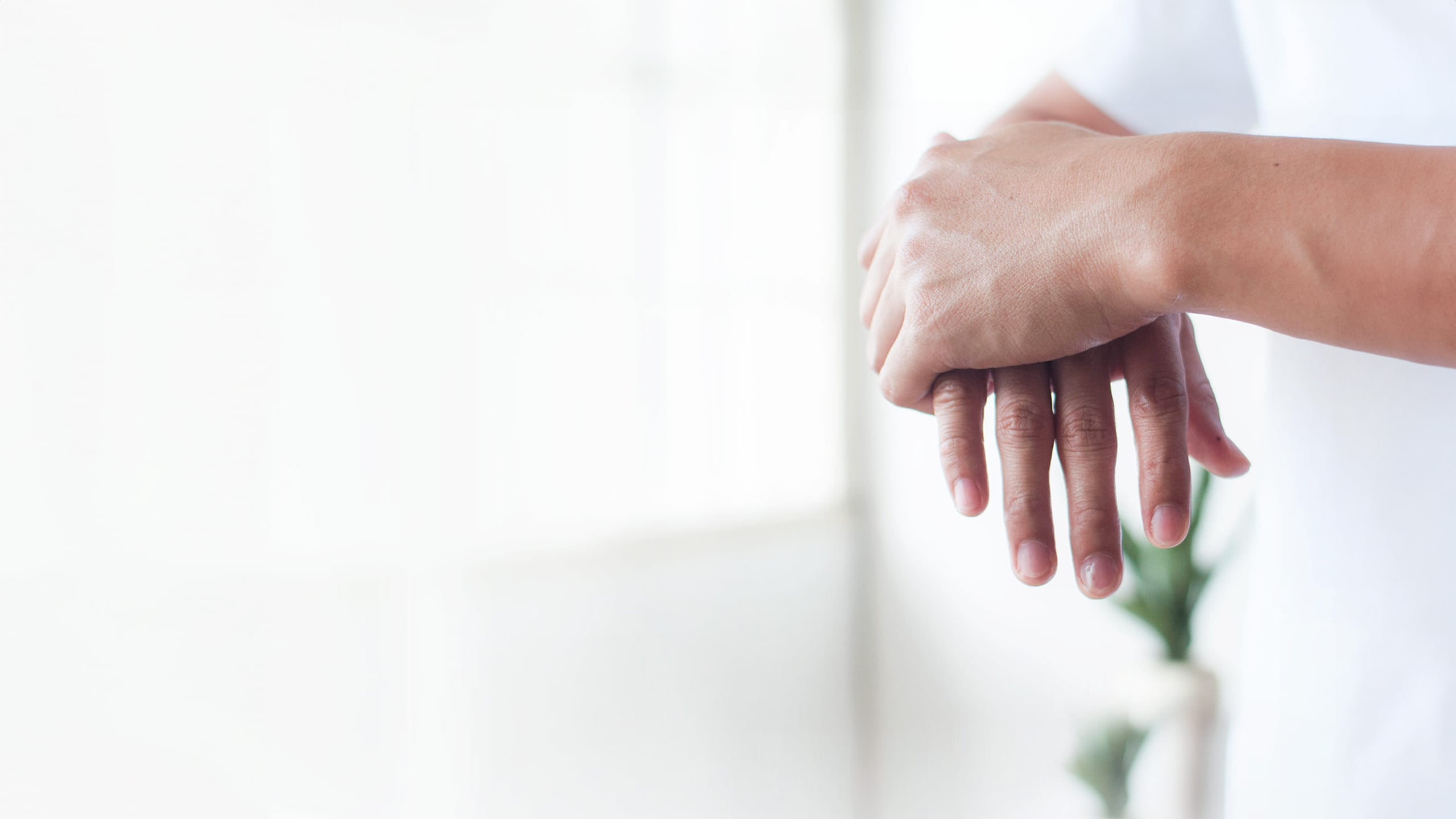 Close up of hands applying hand sanitizer.