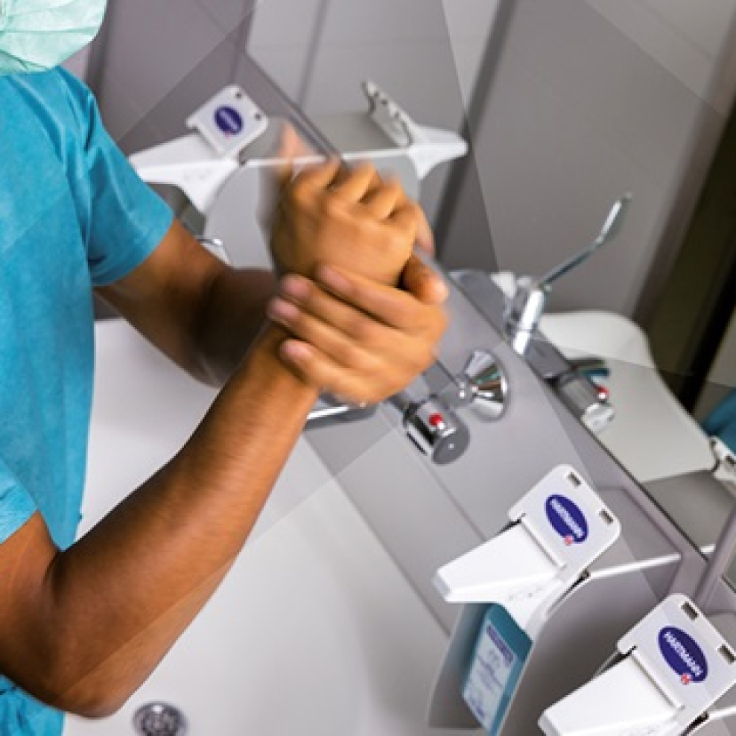 Image of surgeon washes their hands.
