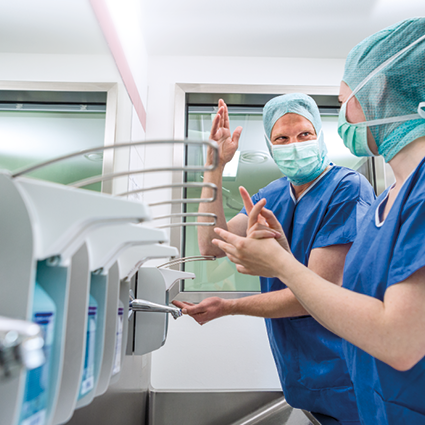 Medical staff performing surgical hand disinfection