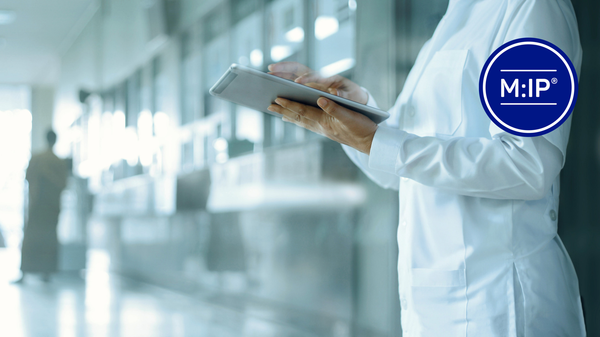 A healthcare professional in a white coat using a digital tablet in a modern medical facility, symbolizing advanced healthcare solutions.