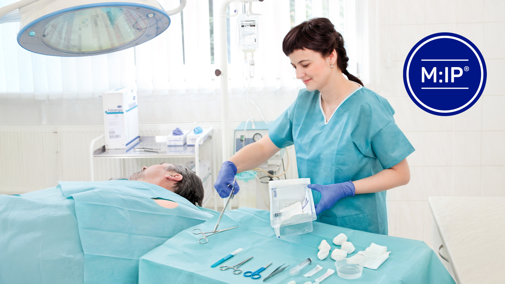 A healthcare professional in teal scrubs carefully prepares medical instruments beside a patient in a clinical setting with MIP branding visible.