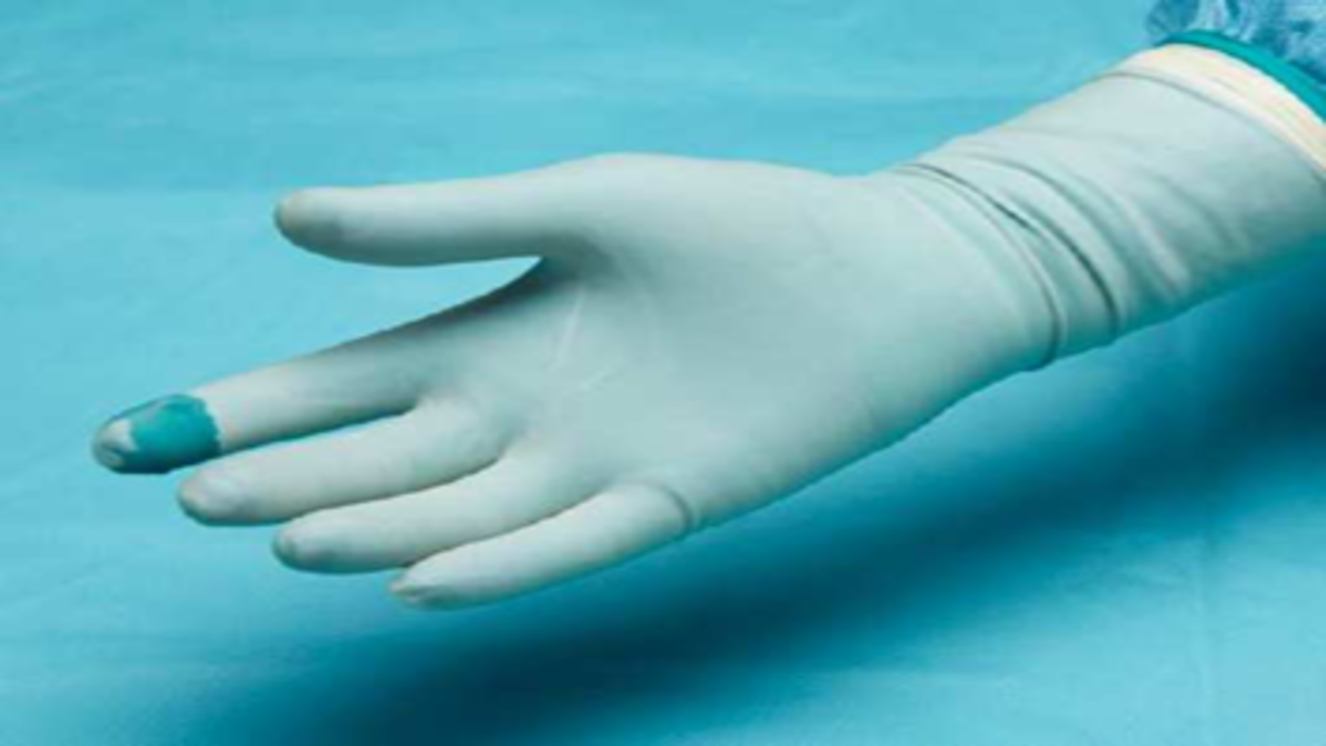 Close-up of a sterile medical glove after puncture