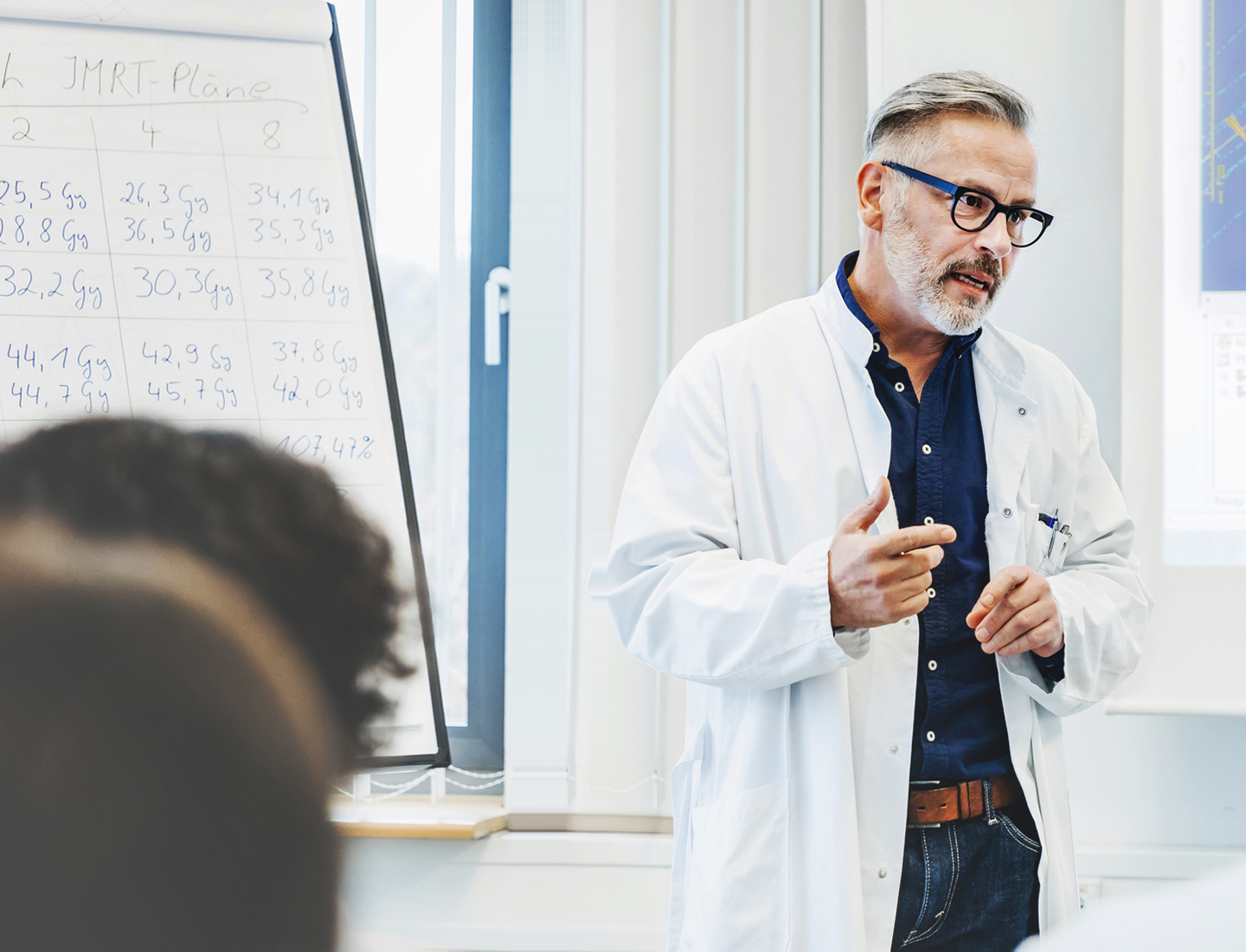 Doctor giving lecture in front of whiteboard