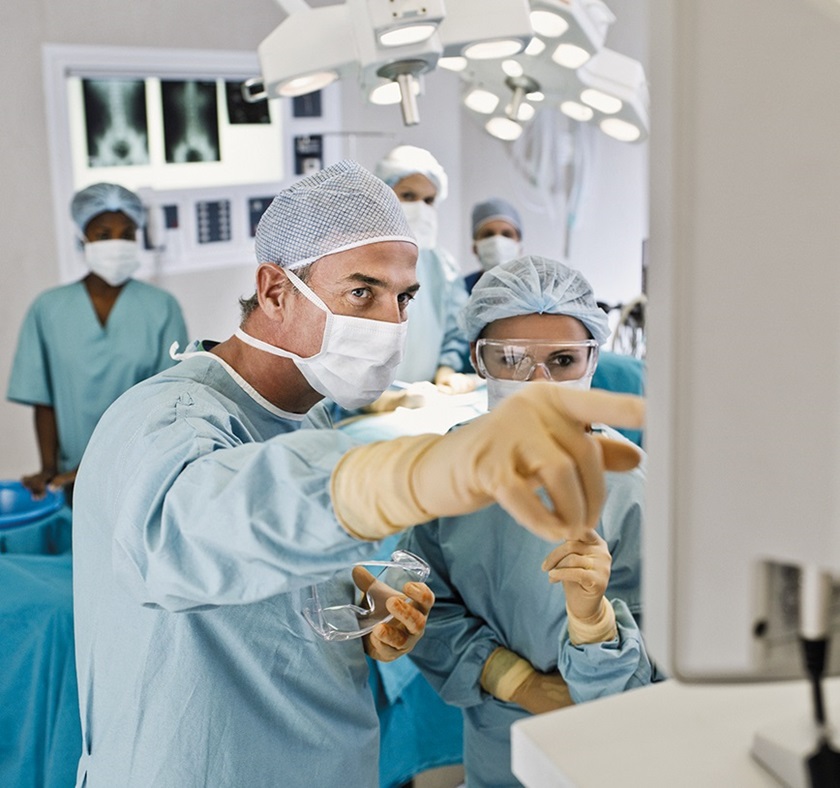 A surgeon is explaining a detail to a colleague