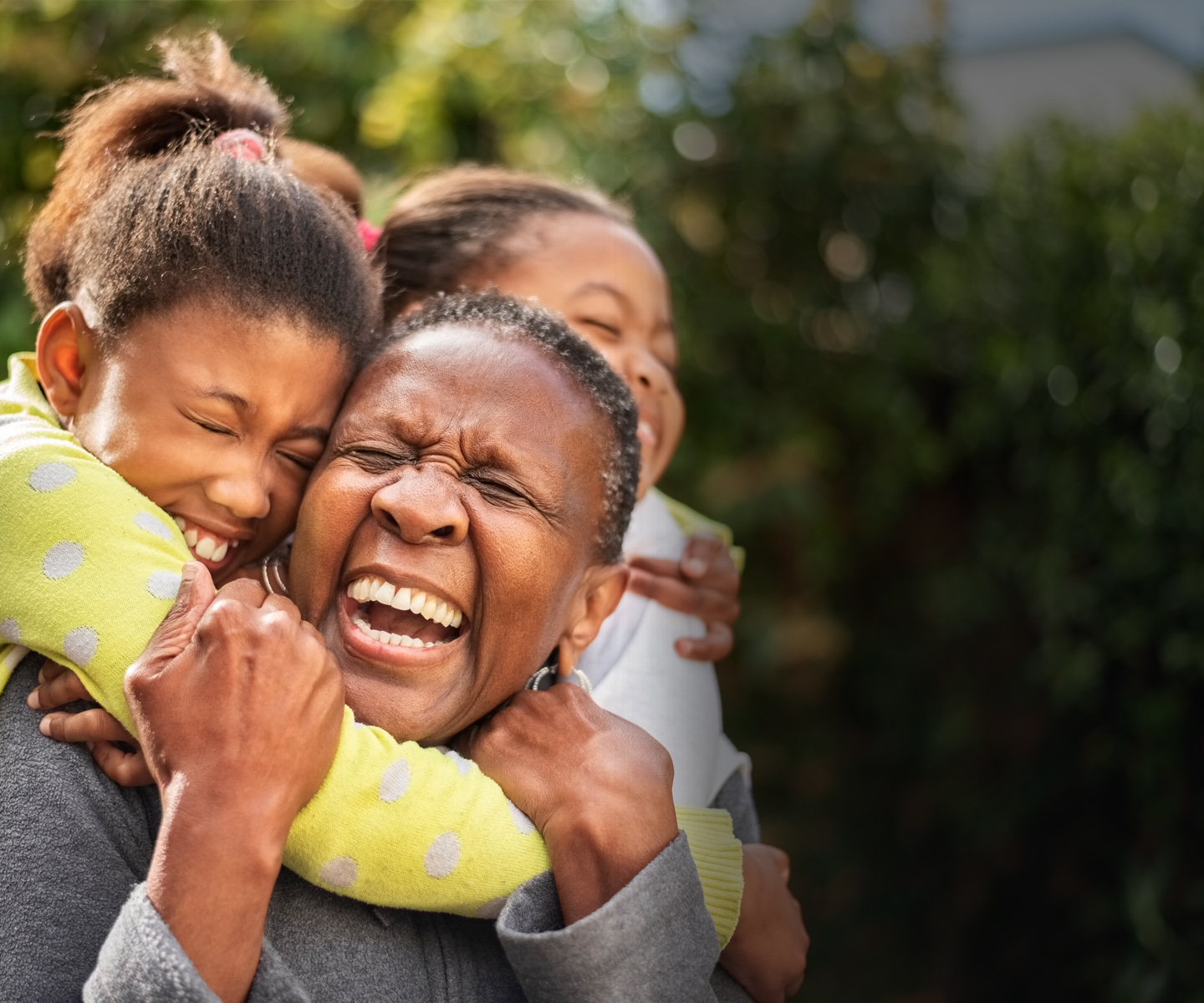 Black elderly women with children smiling